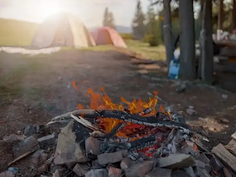 Campfire burning at a campsite at the end of the day
